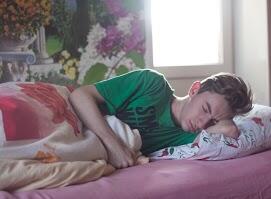 Teen sleeping on a bed